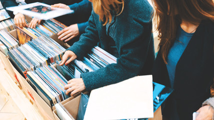 Women Selecting Vinyl Records in a Record Store