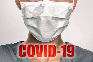 Coronavirus prevention doctor wearing preventive surgical face mask against coronavirus with COVID-19 text in red overlay medical worker background.