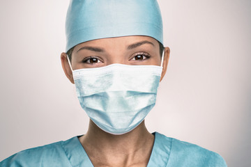 COVID-19 Coronavirus pandemic happy Asian doctor positive with hope wearing surgical mask and blue...