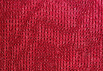 Fototapeta premium The texture of a knitted woolen fabric red.