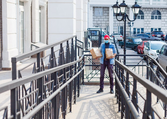 Delivery man holding paper bag with food on white entrance of house background , food delivery man in protective mask