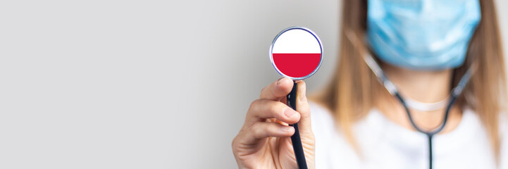 female doctor in a medical mask holds a stethoscope on a light background. Added flag of Poland....