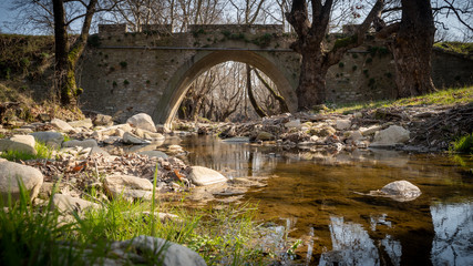 very old stone bridge at forest