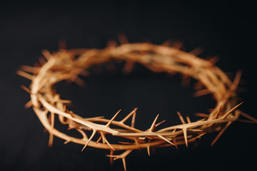 The crown of thorns of Jesus upon holy bible on black  background with copy space, can be used for...