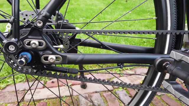 Close up view of belt driven bicycle is a chainless bike that uses a toothed synchronous belt to transmit power from the pedals to the wheel the application is growing especially in commuter market 4k