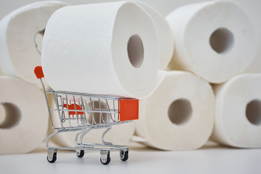 Consumer buying panic about coronavirus covid-19 concept. Toilet paper roll in a shopping trolley. People are stocking up essentials for home quarantine