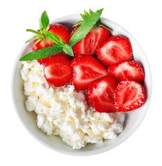 White bowl with fresh red ripe strawberries and natural cottage cheese