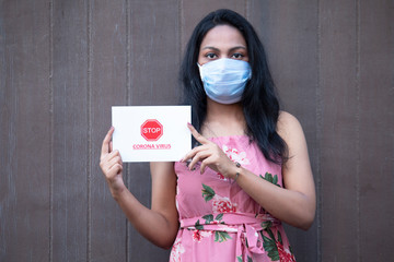 Cautious woman advising masses to socially distance themselves to stop spreading of COVID-19 disease