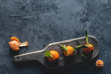 Fresh orange mandarin on wooden cutting board. eco vegetarian. PNOV2019