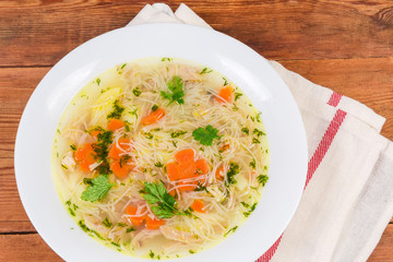 Top view of chicken vermicelli soup in dish close-up
