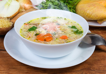 Hot chicken vermicelli soup in bowl against the raw ingredients