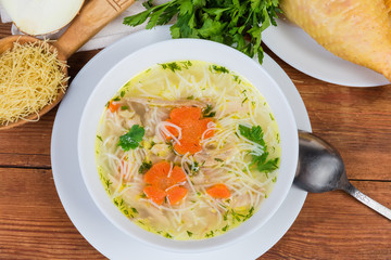 Chicken vermicelli soup and raw ingredients, top view, background