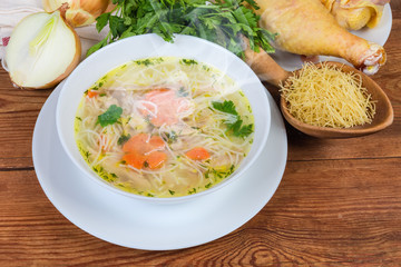 Hot chicken vermicelli soup in bowl and raw ingredients