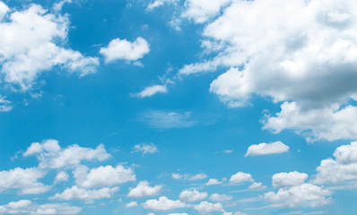 Clouds on bright blue sky with light mild summer scenic background and copy space