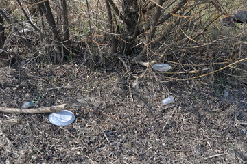 Obraz premium environmental pollution of water, air, and land with plastic, polyethylene, rubber, and glass debris