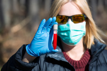 Woman  holding test tube with blood