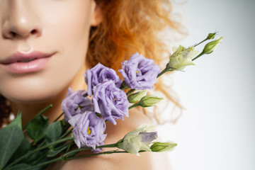 Girl with lilac freesias on her shoulder