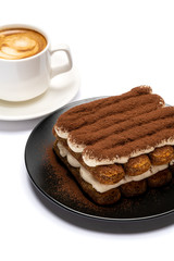 Classic tiramisu dessert on ceramic plate and cup of coffee isolated on white background with clipping path