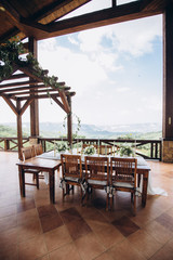 The wedding table decorated with fresh flowers is newlywed with a view of the mountains. 