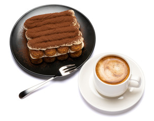 Classic tiramisu dessert on ceramic plate and cup of coffee isolated on white background with clipping path