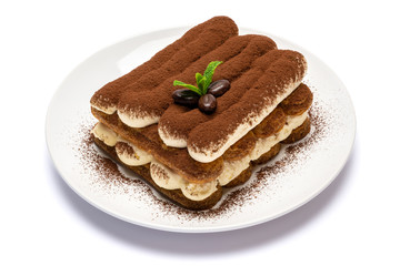 Classic tiramisu dessert on ceramic plate isolated on white background with clipping path