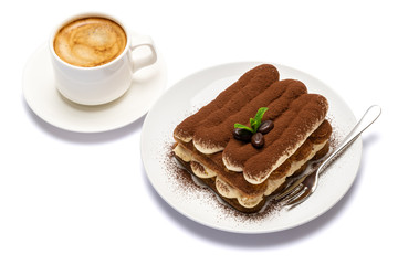 Classic tiramisu dessert on ceramic plate and cup of coffee isolated on white background with clipping path