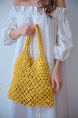 Young girl with brunette hair holds eco bag. Zero wasty. Stop polution be resonsible