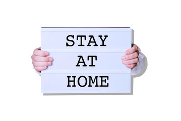 Male hands with Stay At Home sign on white background.