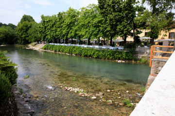 Fototapeta premium Borghetto (VR), Italy - April 30, 2017: Mincio river in Borghetto village, Mincio, Verona, Veneto, Italy
