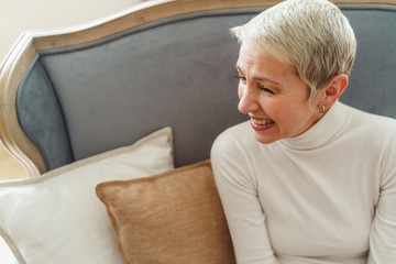 Cheerful Caucasian short-haired elderly lady looking away