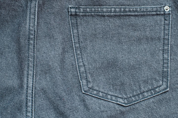 Fragment of gray jeans with a back pocket