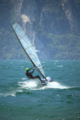 Windsurfing girl planing at Lake Garda (Torbole, Italy)