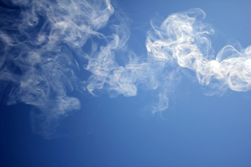 smoke towards the blue sky
