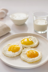 breakfast with fried eggs, yogurt and milk