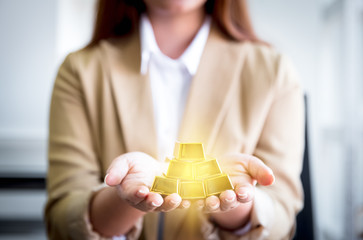woman with gold bars on hands