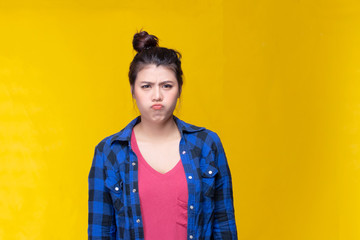Image of feeling excited, shock, surprise and happy. Young asian woman standing on yellow...