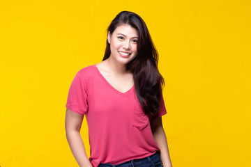 Image of feeling smile and happy. Cheerful young asian woman with brunette long hair in casual shirt smiling with teeth on yellow background. Female face expressions and emotions concept.