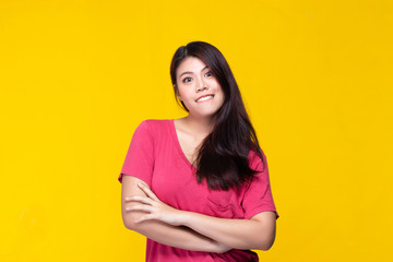 Obraz premium Image of feeling smile and happy. Cheerful young asian woman with brunette long hair in casual shirt smiling with teeth on yellow background. Female face expressions and emotions concept.