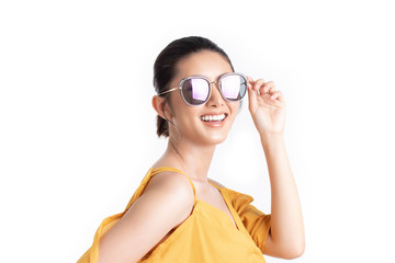 Fashion of a beautiful young asian woman in a pretty yellow dress and sunglasses. Girl posing happy and smiling isolated on white background. fashion beauty and style. Natural skin makeup.
