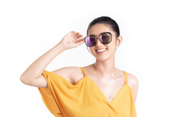 Fashion of a beautiful young asian woman in a pretty yellow dress and sunglasses. Girl posing happy and smiling isolated on white background. fashion beauty and style. Natural skin makeup.