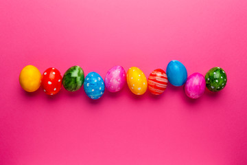 Bright easter eggs on pink background. Retro colorful spring decoration.