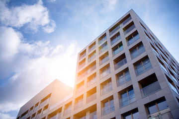 Obraz premium Modern apartment building exterior concept. Sunshine sun flare. 