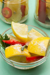 Fermented lemons with salt and chili pepper in jars