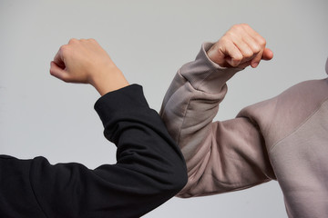 Elbow bumping. A new way of greeting to avoid the spread of coronavirus (COVID-19). A boy and a...