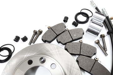brake parts on white: brake pads, disc, brake hose, guides, cylinders .