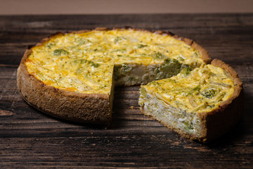 Appetizing kish with broccoli and cheese on on a Wooden Table