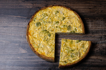 Appetizing kish with broccoli and cheese on on a Wooden Table