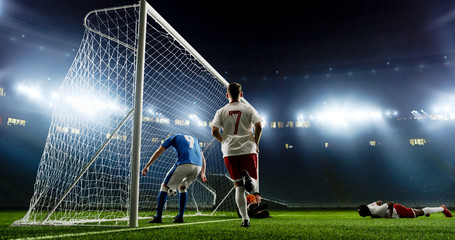 Tense game moment in front of the goal on the empty professional soccer stadium. No spectators on...