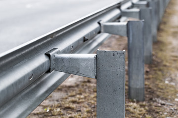 Metal guardrail construction mounted on a highway
