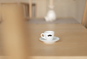 white espresso cup on light wooden table